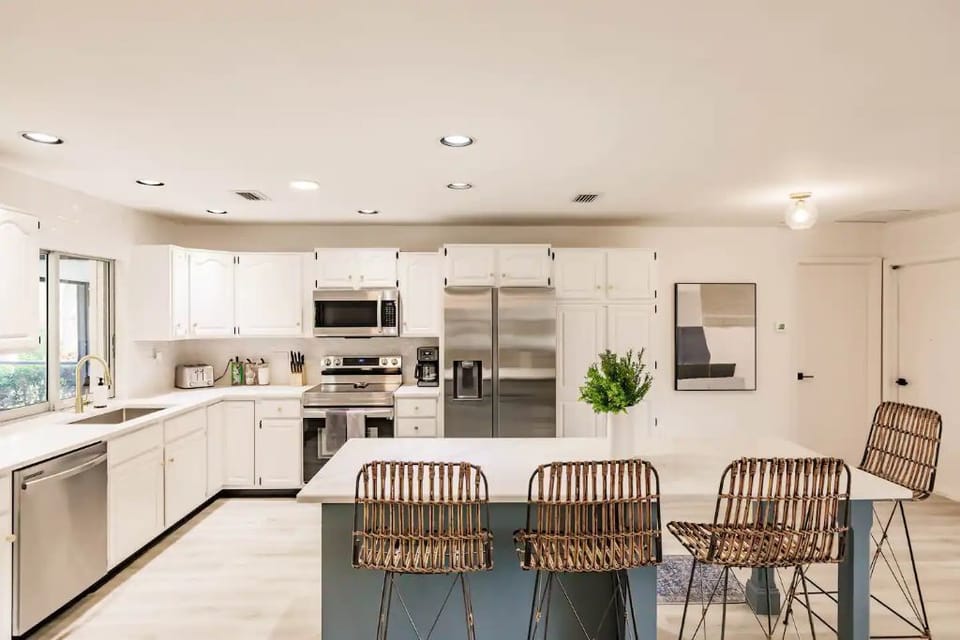 Stocked kitchen w/ window that access outdoor pool bar.