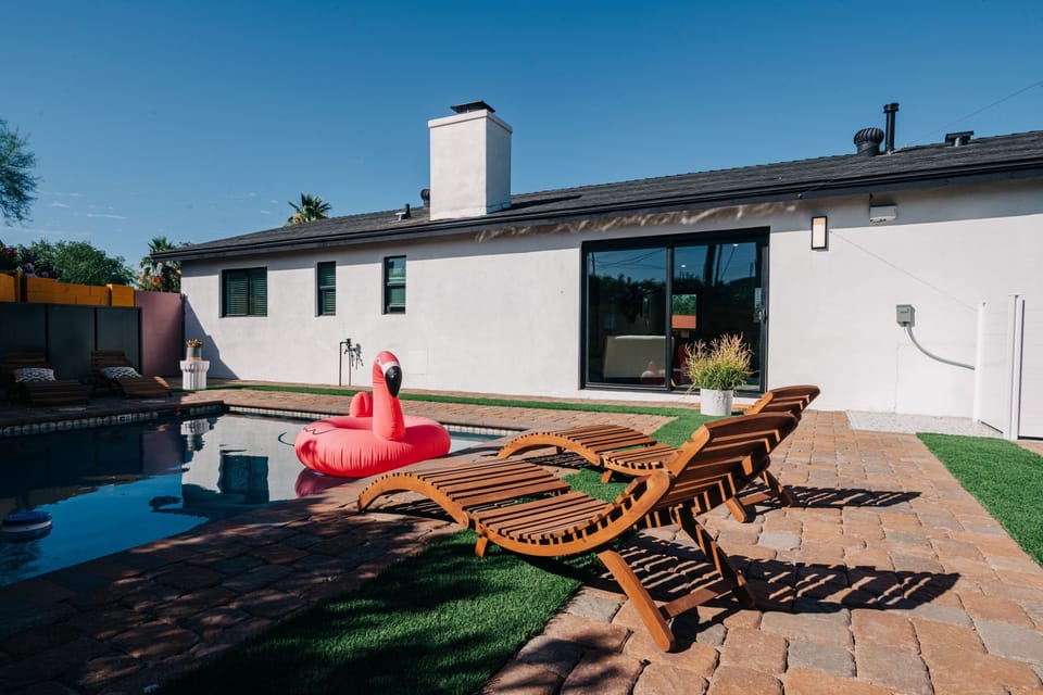 View to the rear sliding door to the living room, loungers and the swimming pool