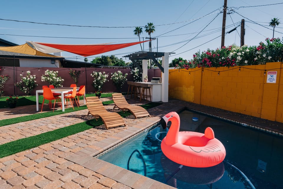 View from the pool to the BBQ island and the shaded dining area