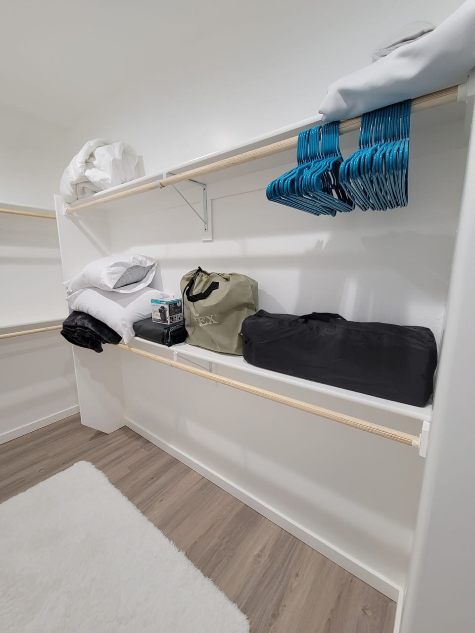 Master closet with queen and full air mattresses, pack and play and hangers.