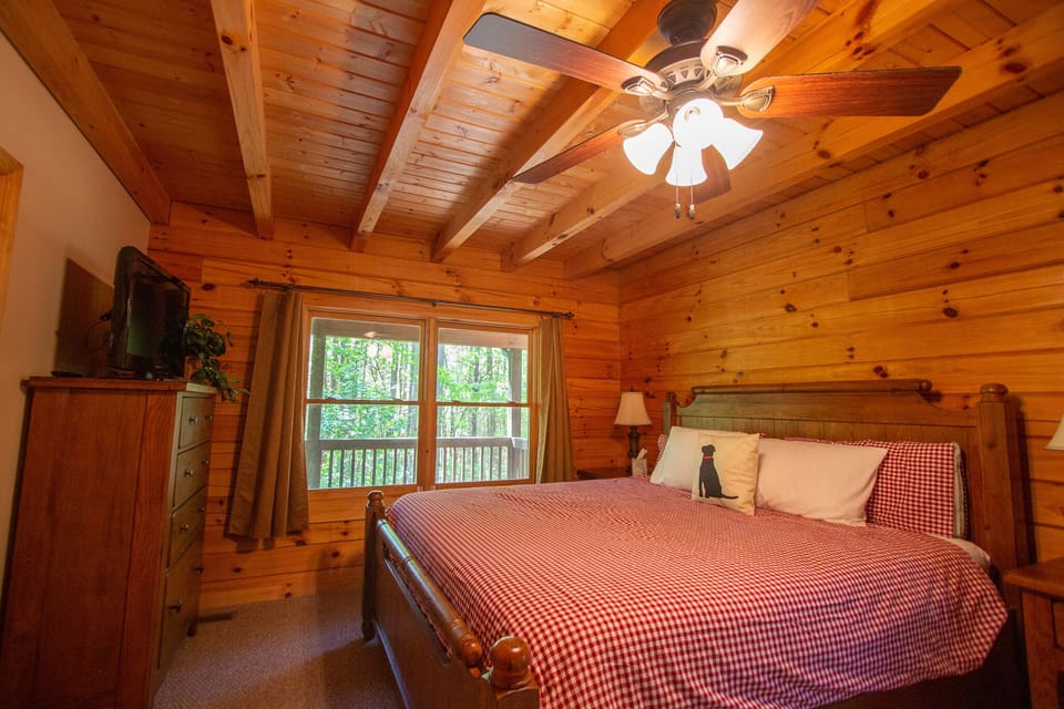 The Master, on the 1st floor, offers  a king bed and a view of the trees.
