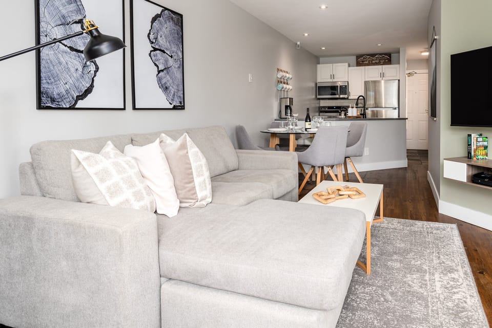 Living Room - Large comfortable couch for post-activity chilling. Wall mounted TV with streaming and satellite channels.