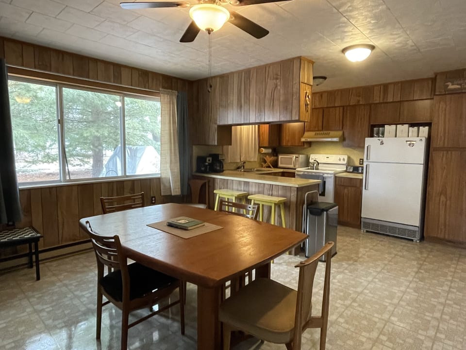 Open dining and kitchen area with large picture windows with lake view