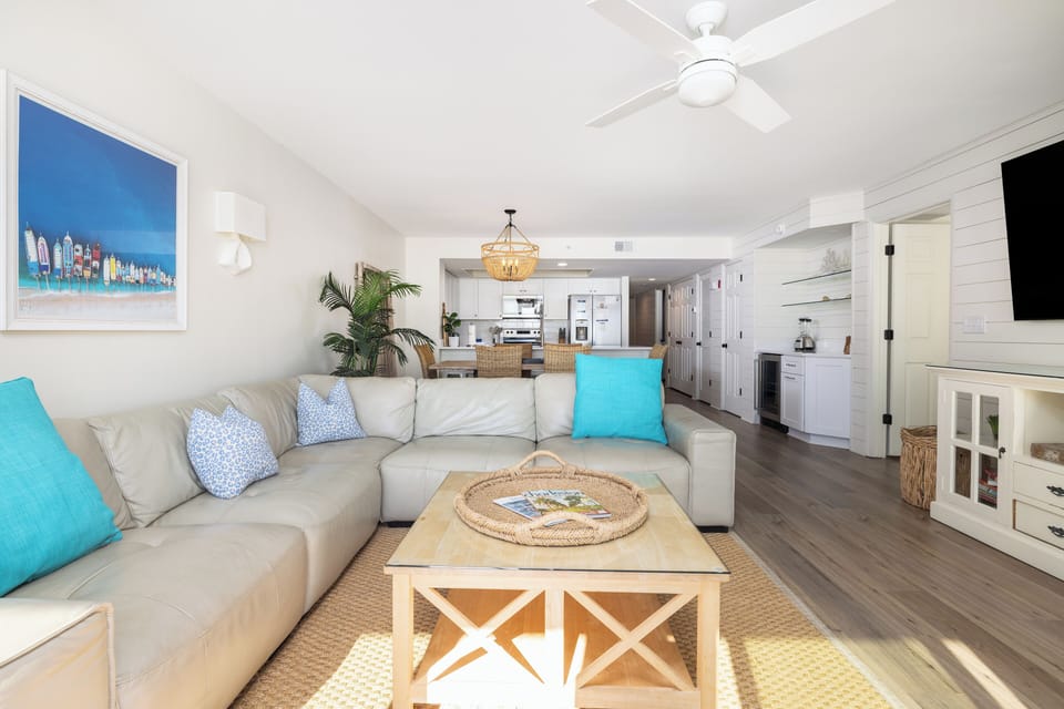 Sink into this bright, beachy living space where turquoise accents and natural textures create your perfect coastal retreat.
