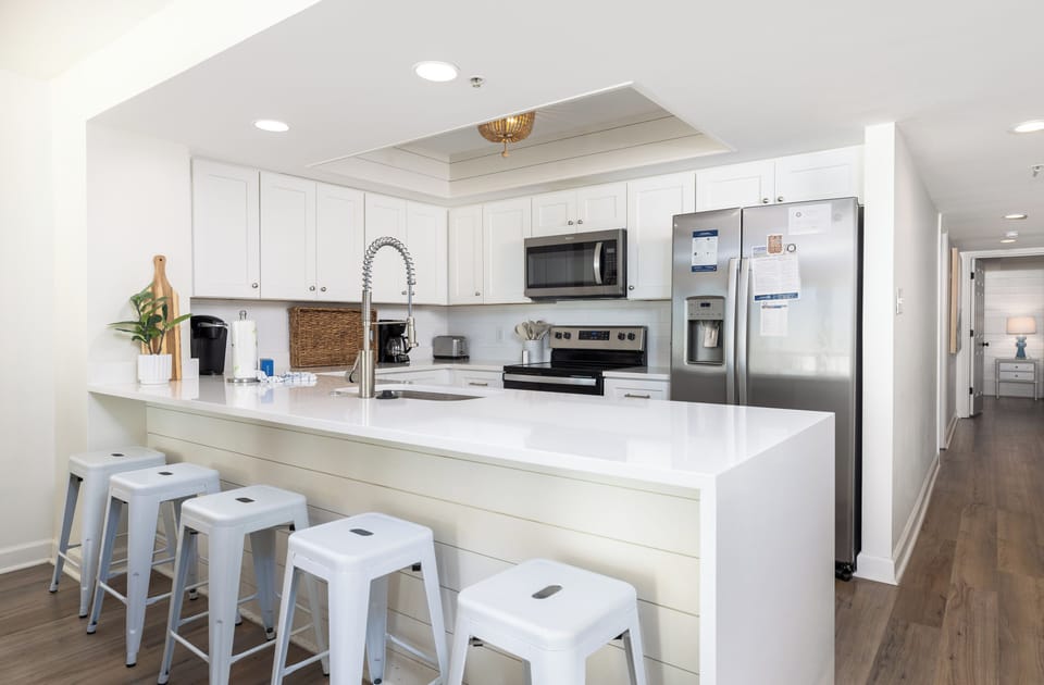 Cook memorable meals in your fully equipped kitchen, complete with modern appliances and a breakfast bar perfect for morning coffee.