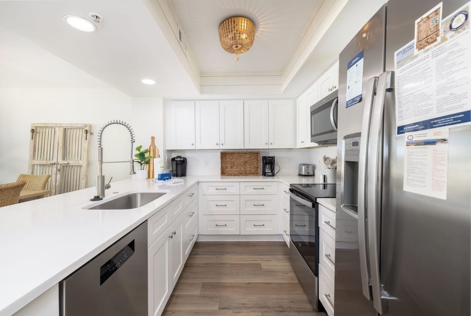 Cook up your favorite meals in this bright, fully-equipped kitchen with stainless steel appliances, quartz countertops, and plenty of prep space.