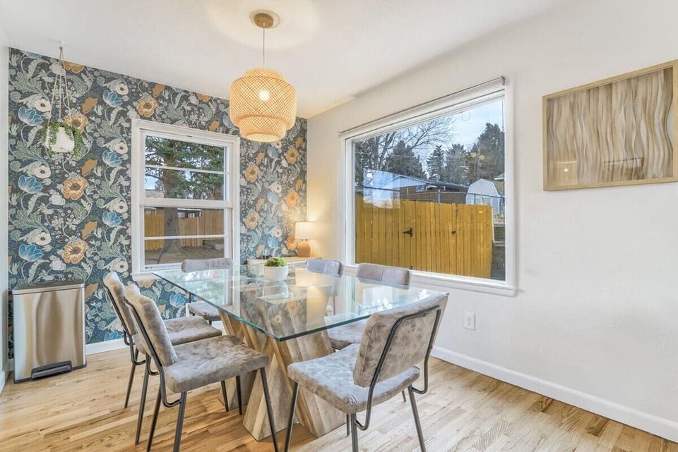 Elegant Dining Space: Spacious Table, Ample Seating, Enchanting Ambiance, and Abundant Natural Light from Expansive Windows!