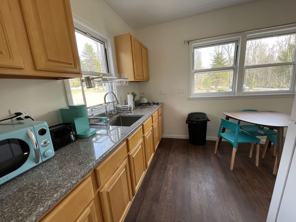 Unit three kitchenette with stove, microwave, fridge, toaster, coffee maker. 