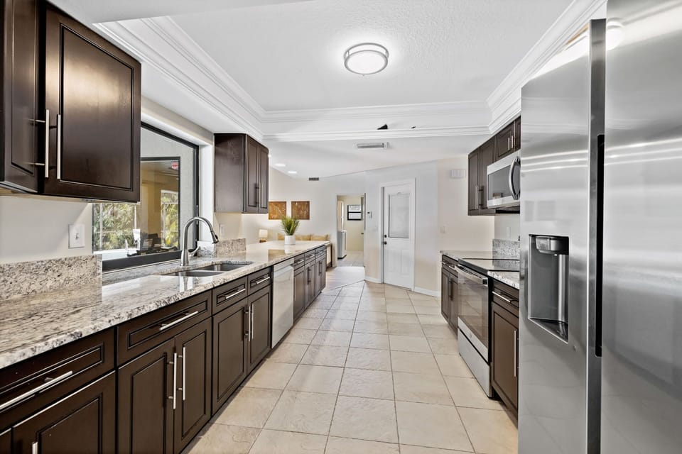 The kitchen is fully equipped with stainless steel appliances.
