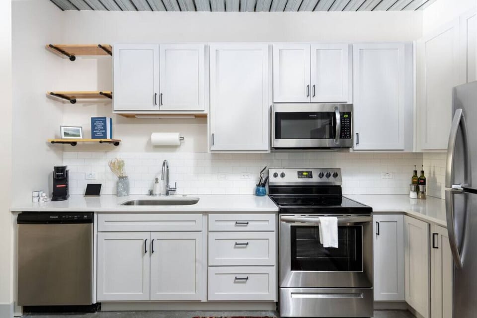 A fully equipped kitchen with sleek cabinetry and modern appliances—perfect for whipping up a quick breakfast or a gourmet dinner