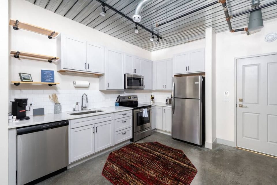 A fully equipped kitchen with sleek cabinetry and modern appliances—perfect for whipping up a quick breakfast or a gourmet dinner