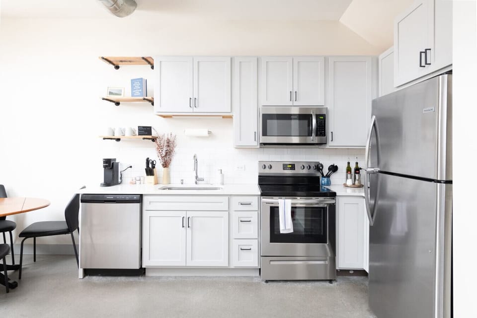 A fully equipped kitchen with sleek cabinetry and modern appliances—perfect for whipping up a quick breakfast or a gourmet dinner