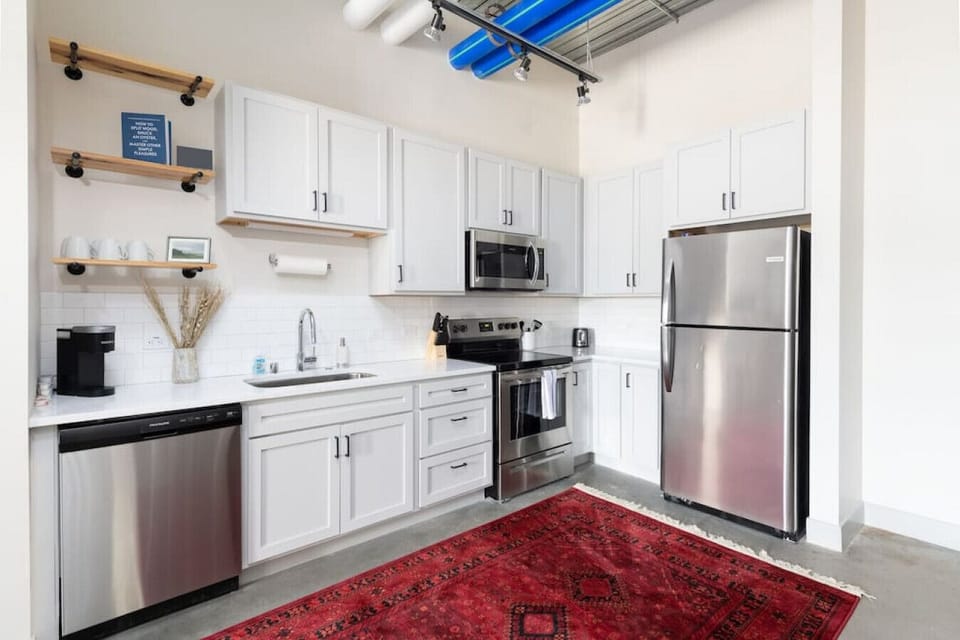 A fully equipped kitchen with sleek cabinetry and modern appliances—perfect for whipping up a quick breakfast or a gourmet dinner