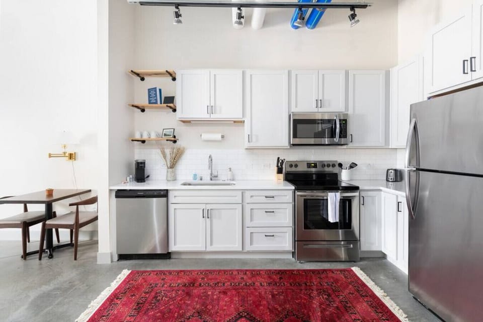 A fully equipped kitchen with sleek cabinetry and modern appliances—perfect for whipping up a quick breakfast or a gourmet dinner