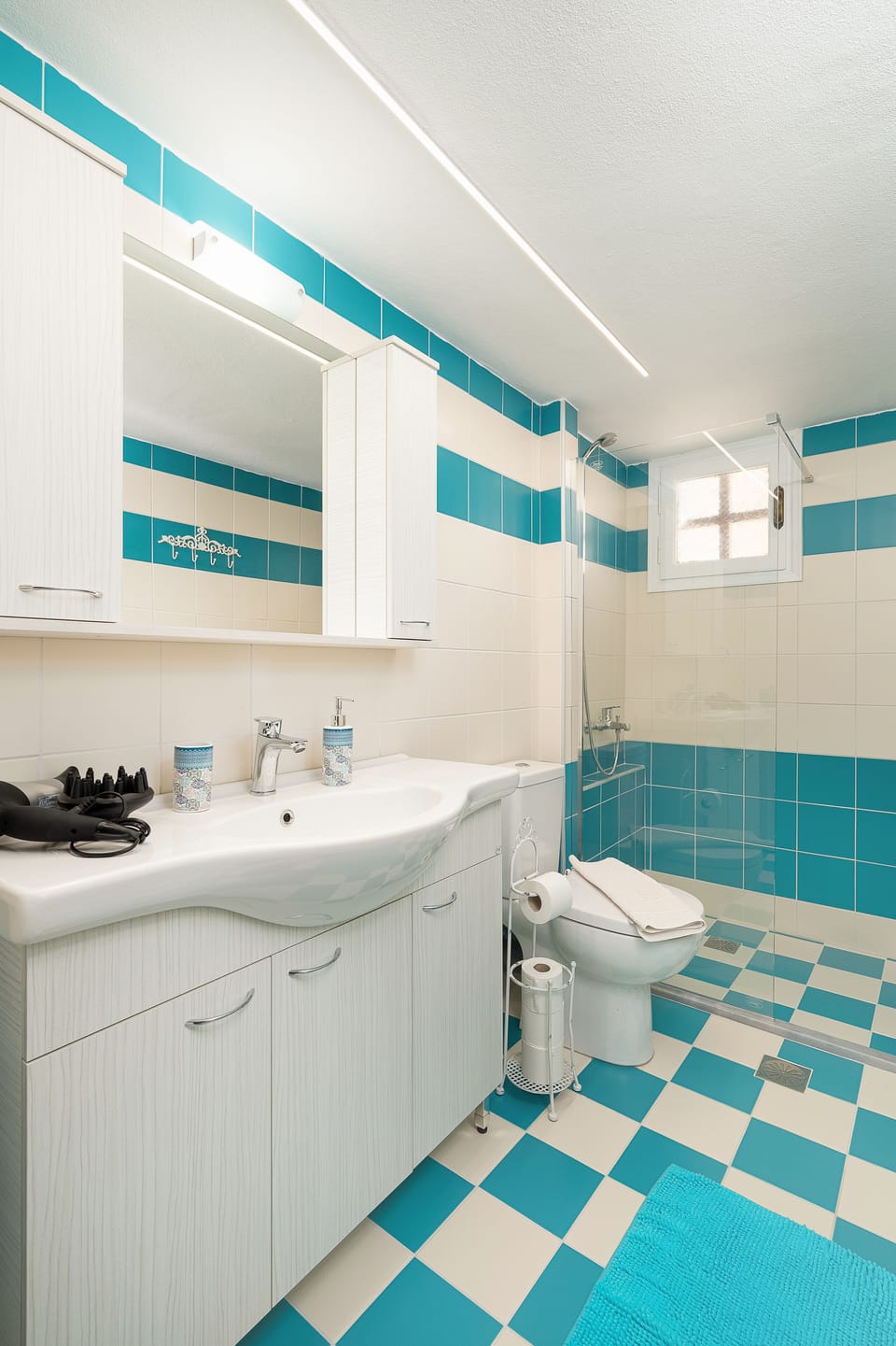 Bathroom, walk in shower, toilet and sink area.