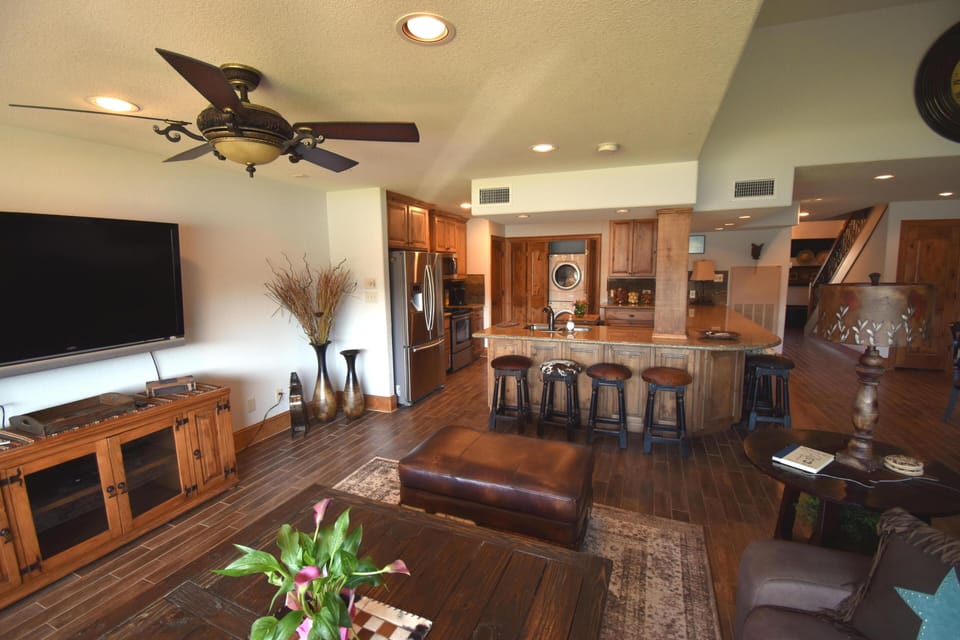 Spacious and comfortable living room with flat screen television.