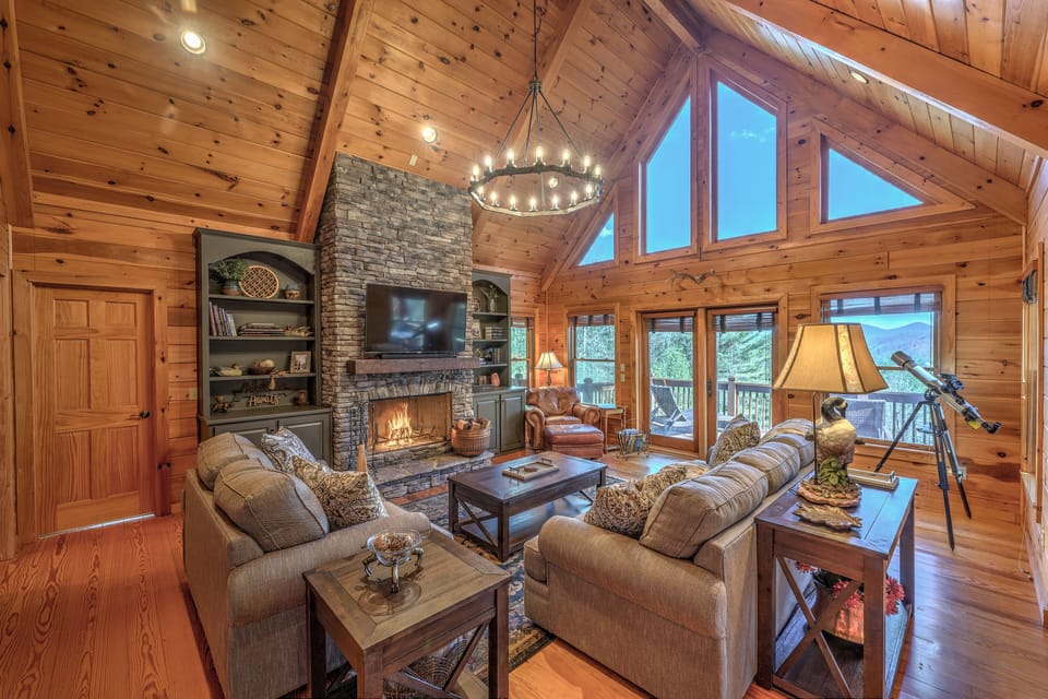 Main level living room with a view, game cabinet, telescope, wood fireplace 