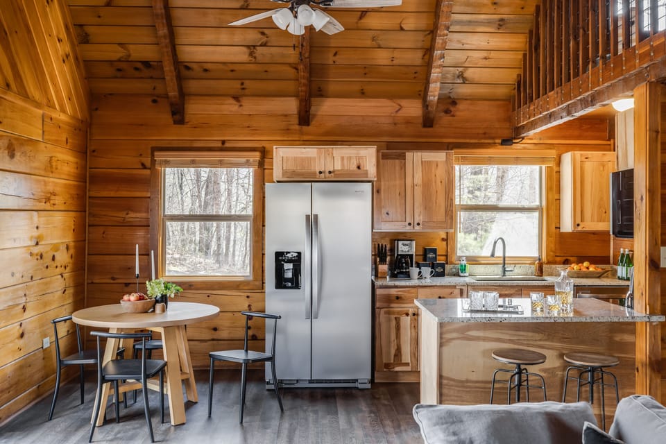 Kitchen features modern appliances and an island with counter-top seating.