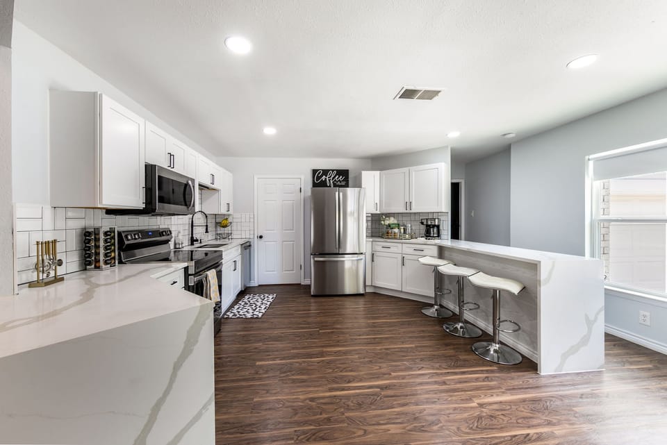 Fully stocked kitchen with waterfall quartz countertops