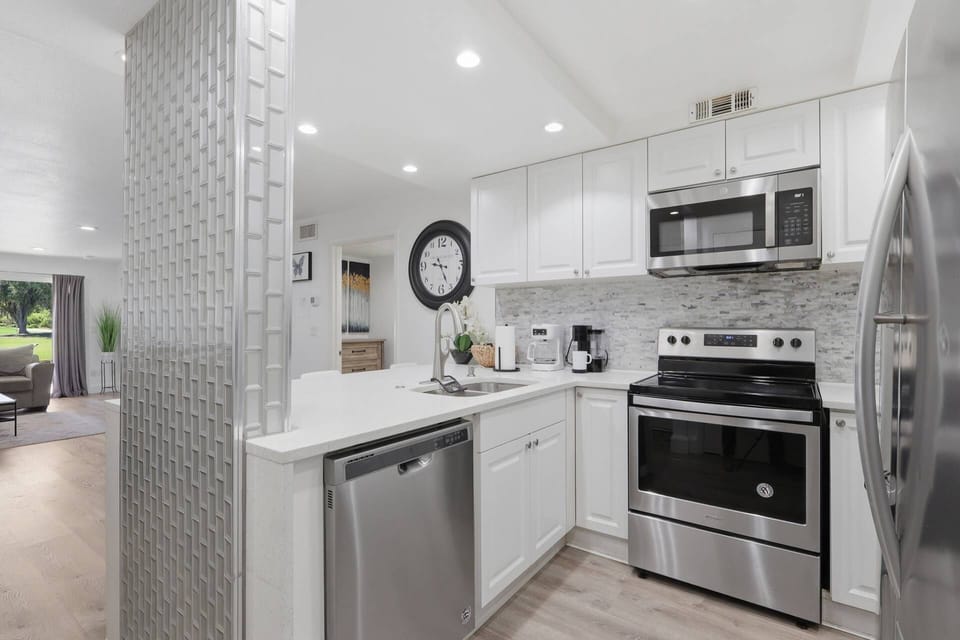 This sleek kitchen is designed for convenience with ample counter space, modern finishes, and everything needed for meals at home.