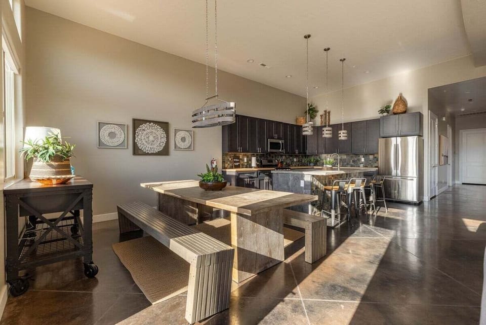 This dining area features a stunning farmhouse table that seats 8 comfortably, is perfect for big family dinners or festive get-togethers. The rustic charm and ample space invite you to relax and enjoy each other's company.