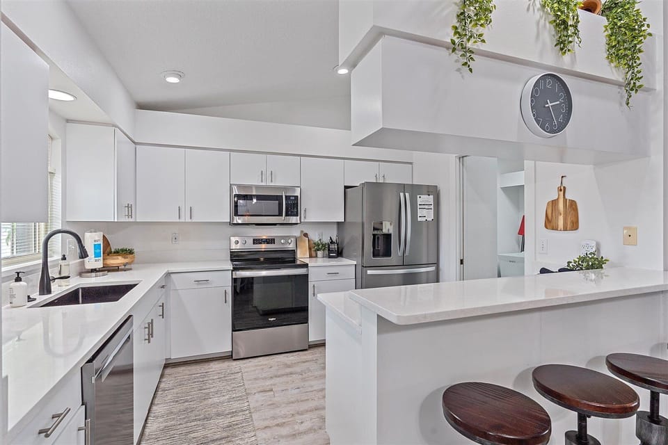 Fresh white kitchen cabinets w/ plenty of countertop space.