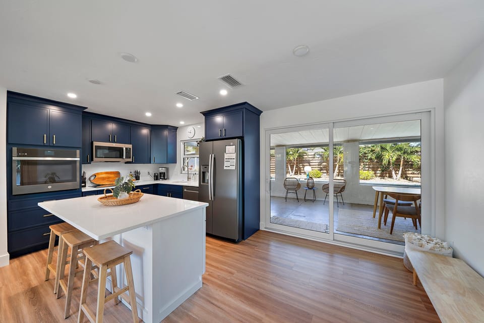 This spacious, fully-equipped kitchen is a chef's dream! You can see the entry door through the laundry room on the left.