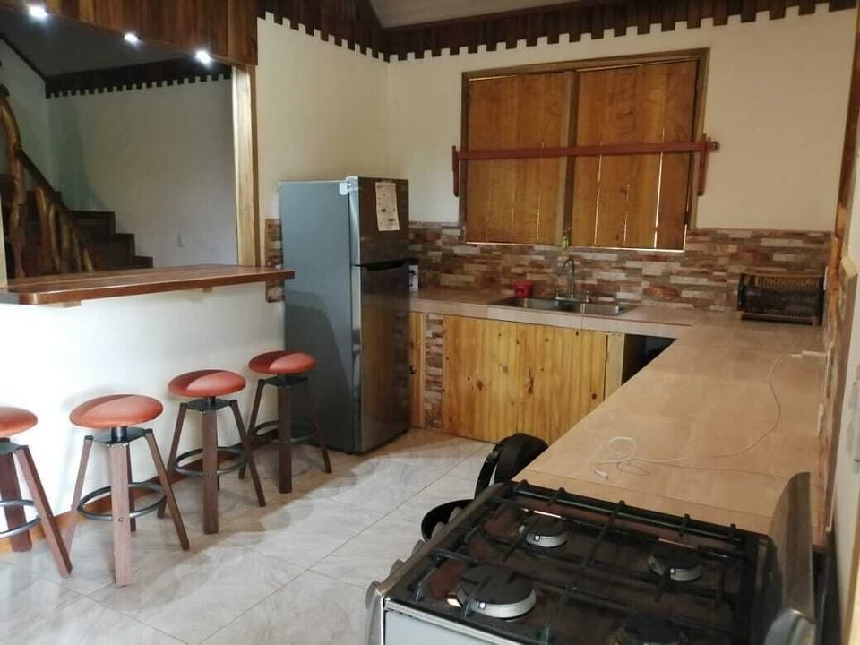 Looking in kitchen from side entrance door. Kitchen Bar table n stools.