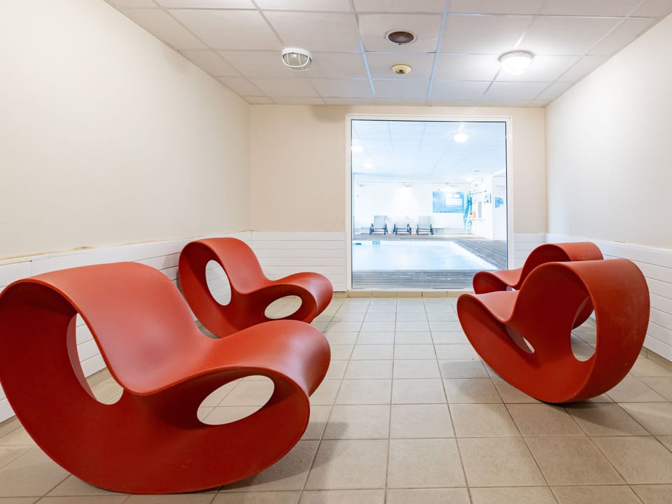 Relax in modern, sculptural seating that invites you to unwind before your swim.