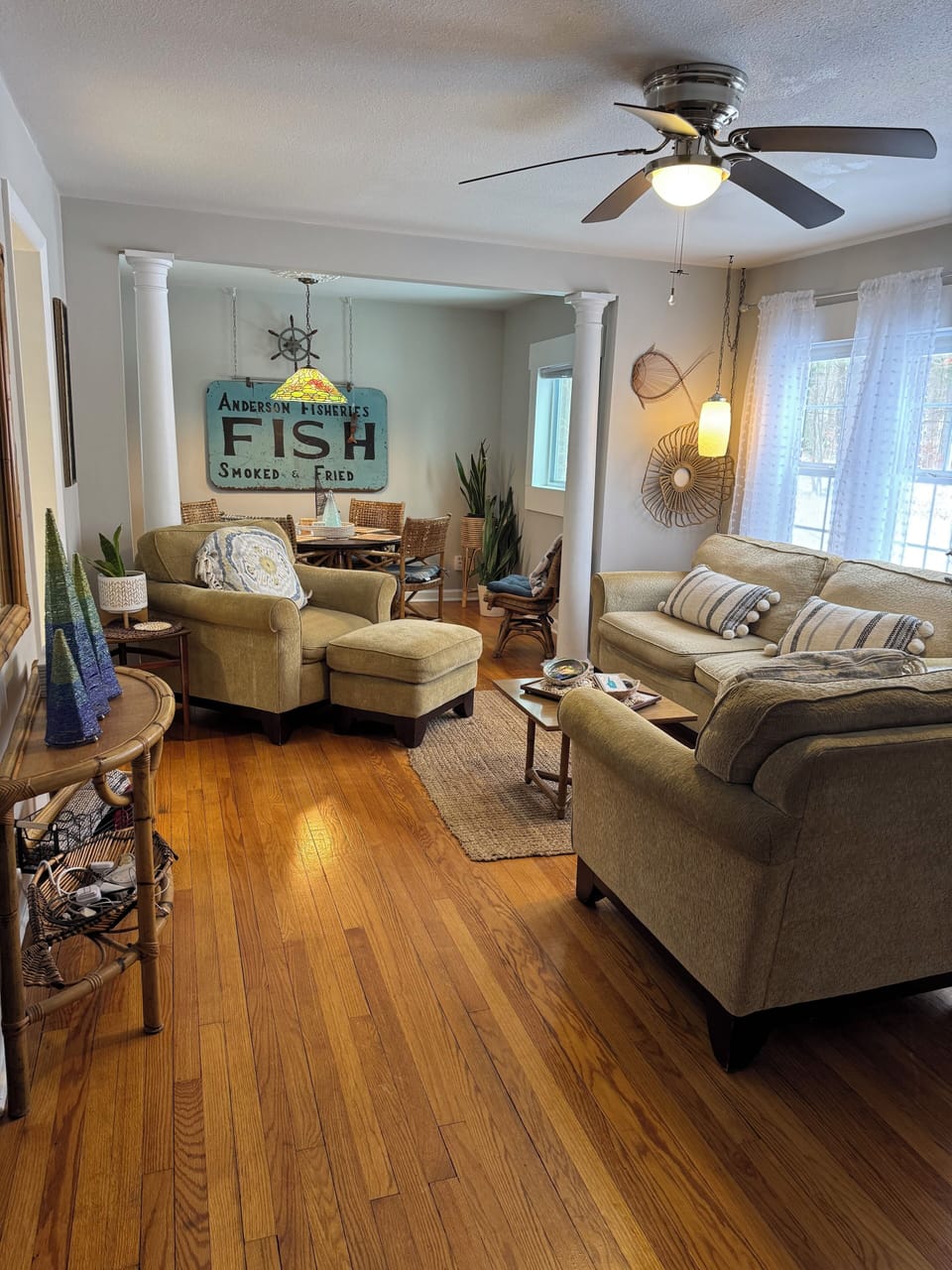Living room with large tv and 4 seated table with games & puzzles
