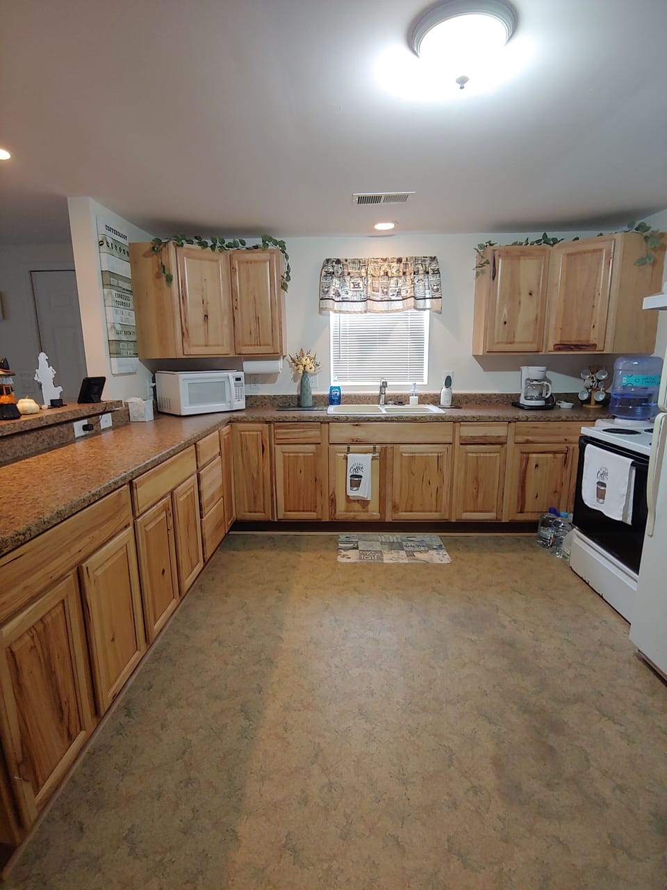 Kitchen - stove, fridge, primo water dispenser.  All utensils cookware,coffeepot
