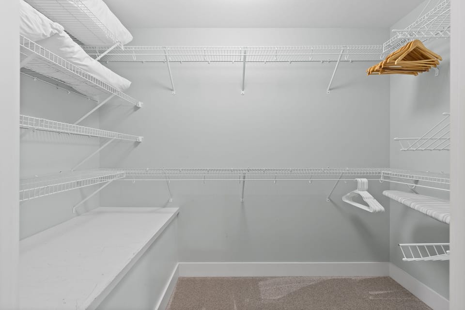 Plenty of space in the master closet for hanging clothes, ironing, or luggage.