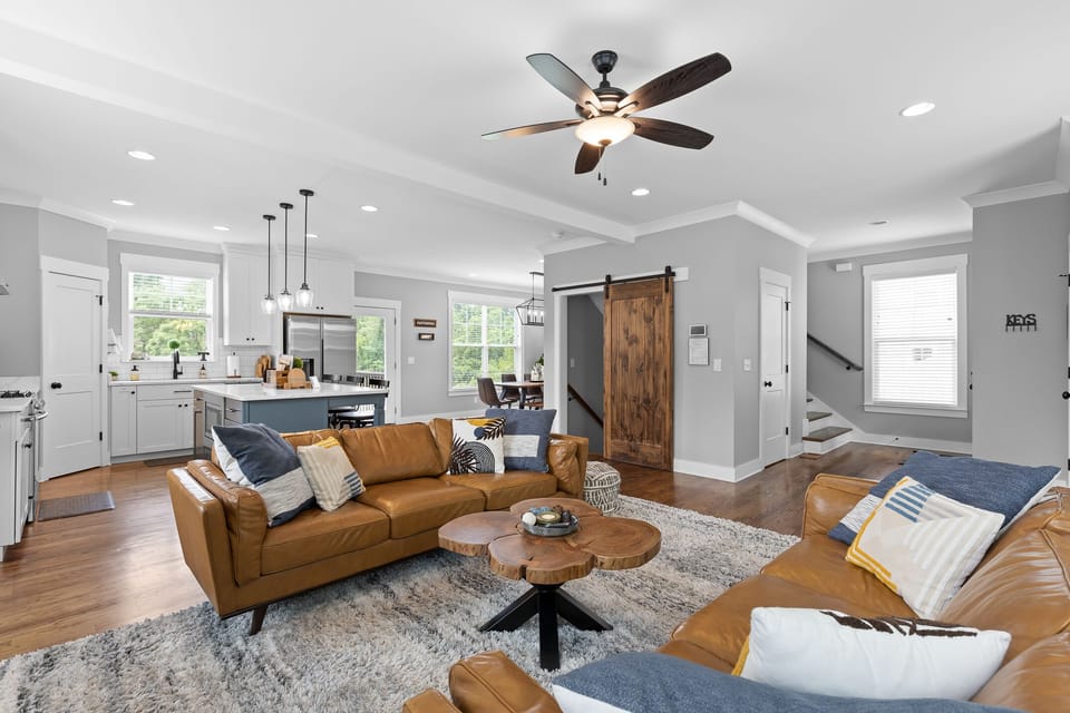 Two large leather sofas, inviting spaces with lots of natural light to relax!