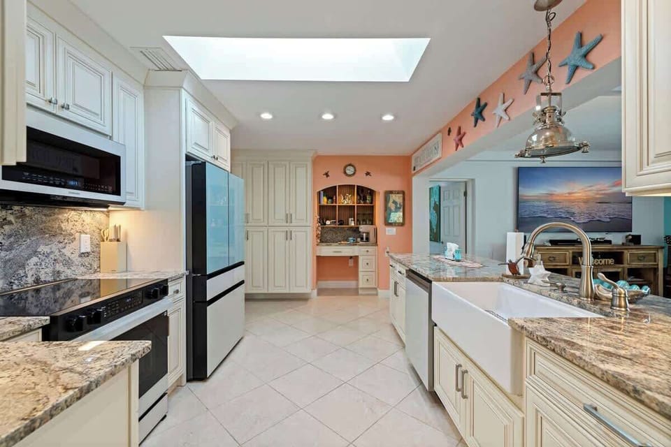 Warm under-cabinet lighting highlights the granite countertops, adding both style and function while creating a cozy, inviting glow perfect for evening cooking and entertaining.