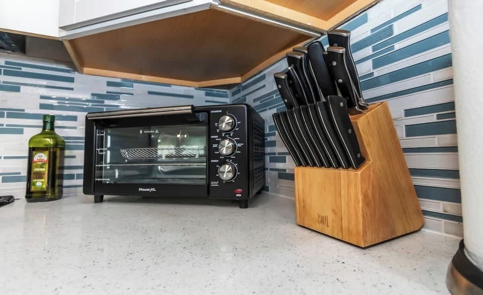 Air Fryer/Toaster Oven combo! This thing is amazing! You can bake, broil, toast, grill or fry. (Additional trays are located in cabinet above) 