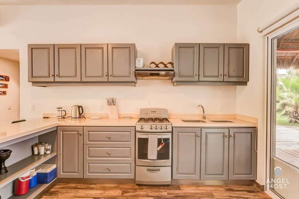 Fully equipped kitchen with a breakfast bar seating four.