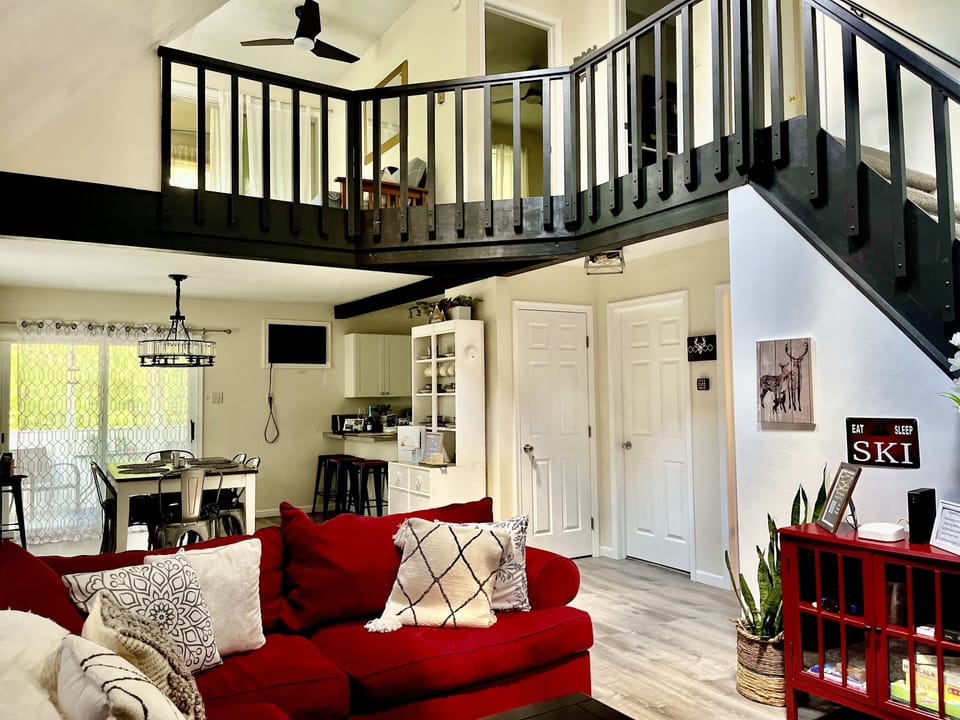 The family living room has a wood burning fireplace w/ Smart TV, & comfy couch.