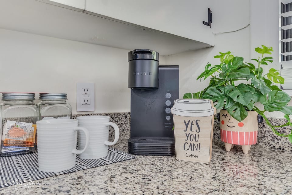 Keurig with pods, cream and sugar.