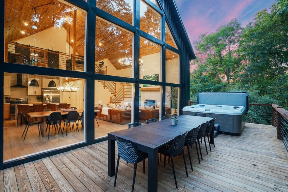The oversized back deck which spans the entire width of the cabin is gorgeous! Here you`ll find a 6-person hot tub, 10-seat dining table, Kenmore grill, and beautiful forest views.