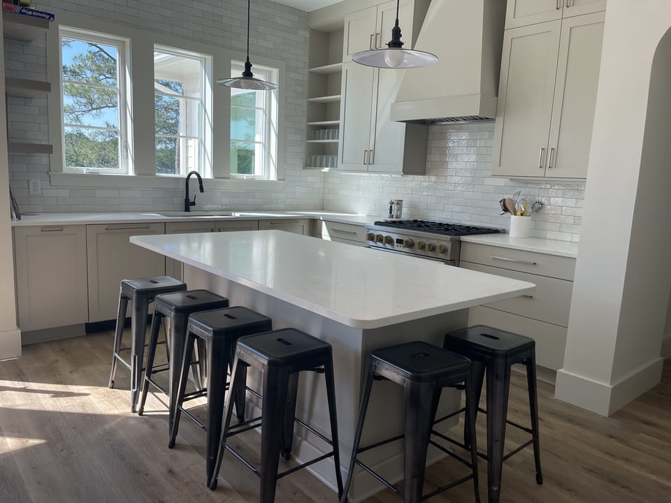 Professional kitchen- 6-burner gas stove and two dishwashers. Island seats six.