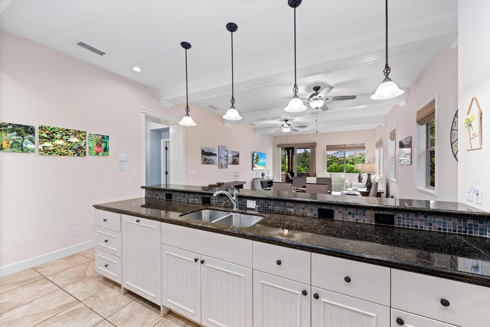 Full kitchen with breakfast bar and granite counters