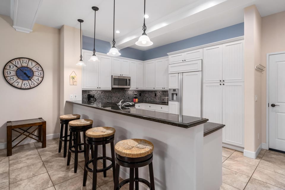 Full kitchen with breakfast bar and granite counters