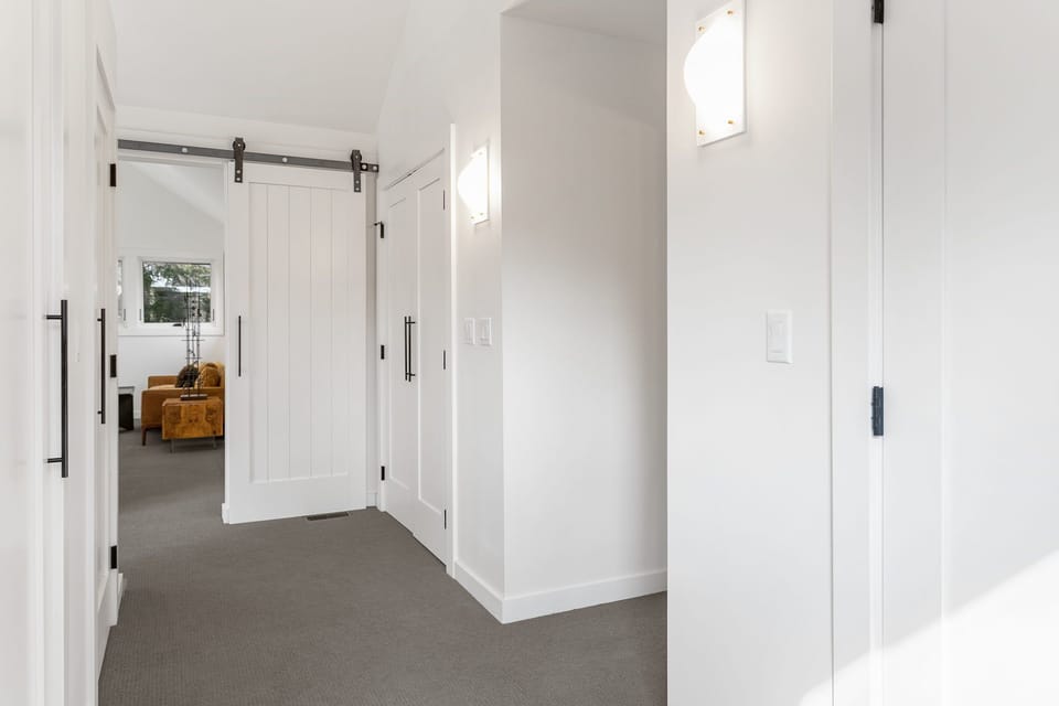 MAIN HOUSE LOFT BEDROOM CLOSET AREA .  AREA LEADING INTO BATHROOM.