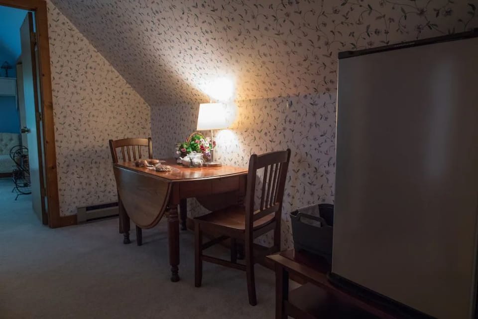 A small refrigerator and dishpan provided.