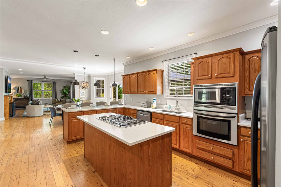 Indulge in the luxury of a 5-burner gas cooktop on the island, which makes group meal preparation a breeze. Visit “The Space” to read more about the kitchen.