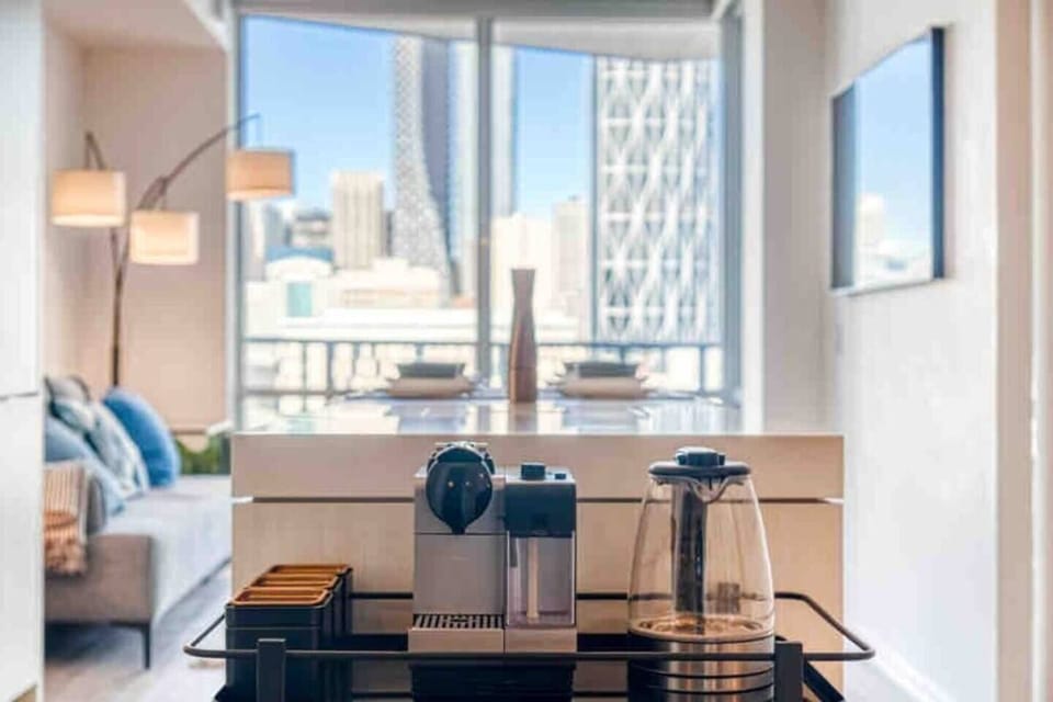 Stylish living space surrounded by natural light and skyline vistas.