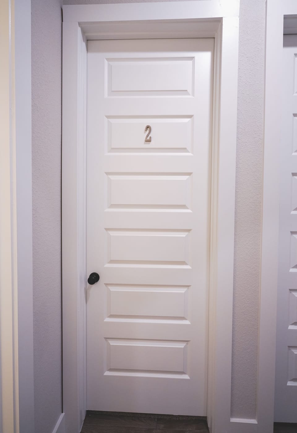 Room #2 is the first bedroom next to the shared bath on the left of the hallway.