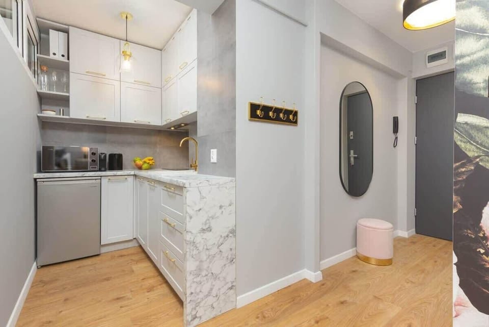 Elegant hallway with marble accents, soft lighting, and a functional design.
