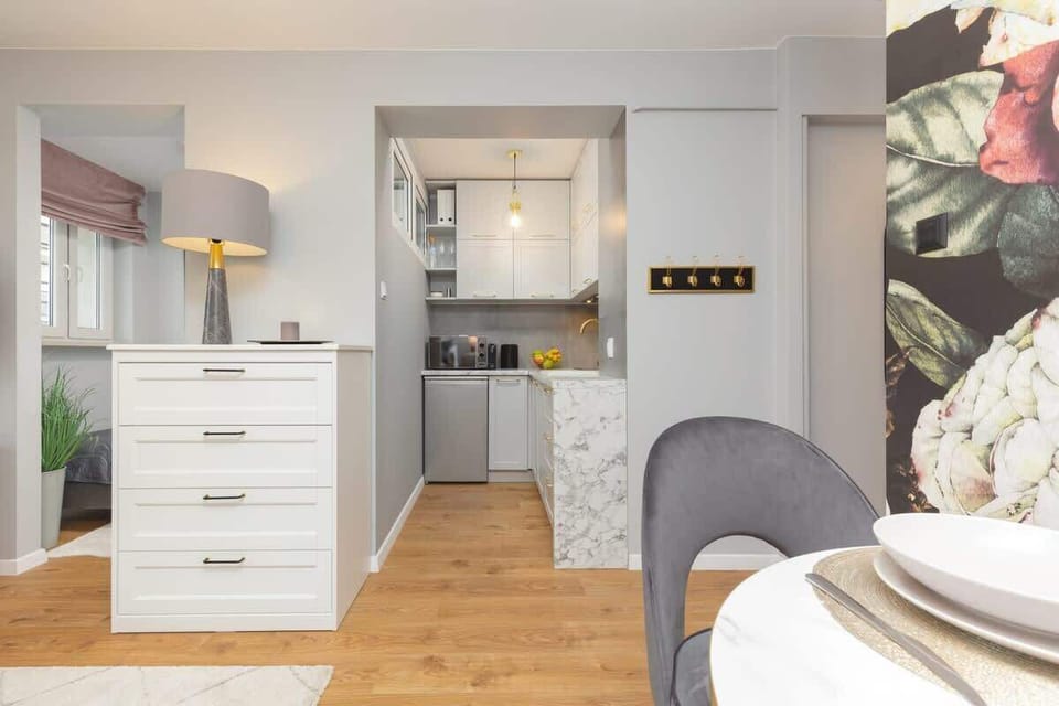 Open-plan view of the living space leading to the kitchen and hallway.
