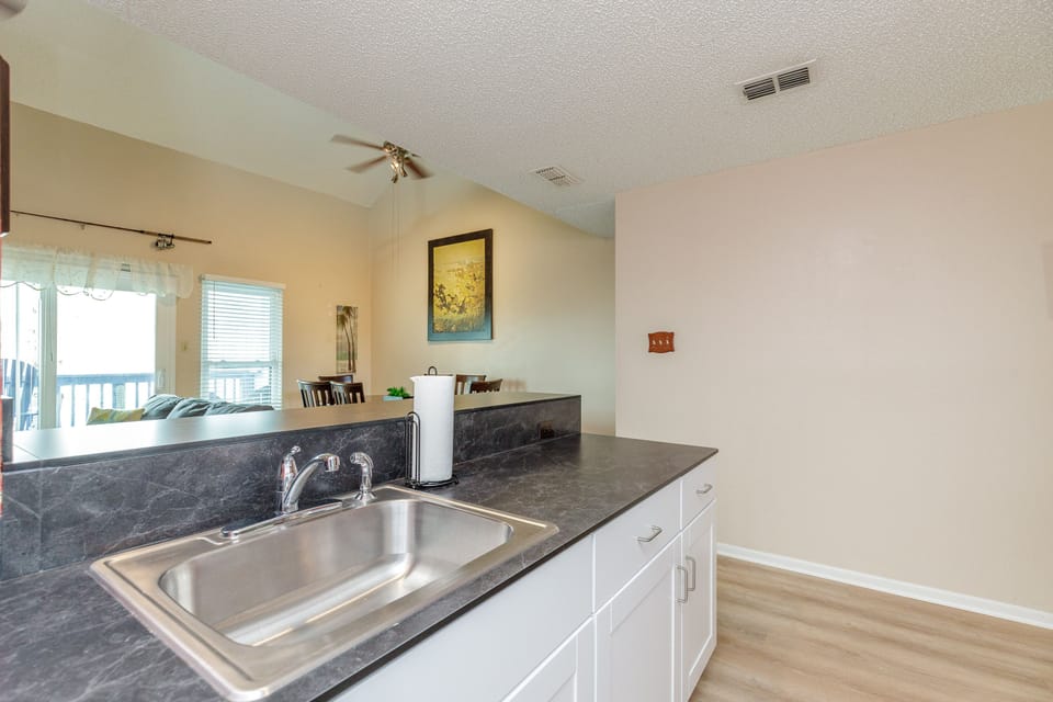 Your spacious kitchen features granite countertops, stainless steel sink, and opens to the dining area—perfect for preparing meals together.